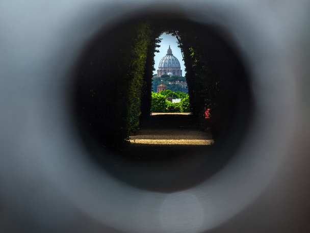 The dome of Saint Peters Basilica seen through the famous keyhol - Photo, Image