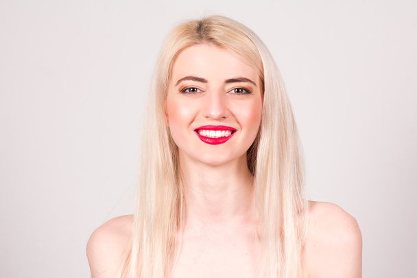 Blonde woman with red lips, make-up and smile with teeth. Beauty concept. - Фото, зображення