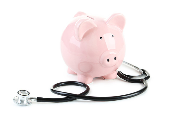 Pink piggy bank with stethoscope - Foto, imagen