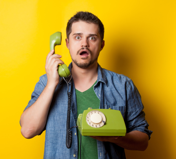 guy in t-shirt with green retro phone - Photo, Image