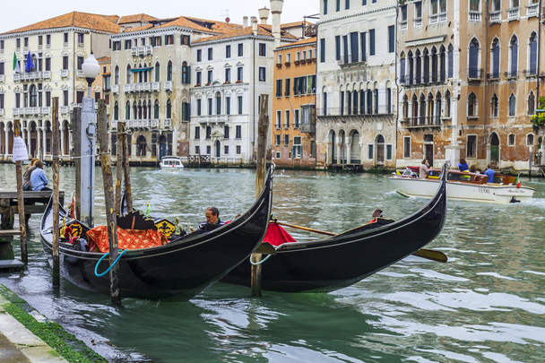 VENICE, ITALY - on APRIL 29, 2015. Two gondolas are moored at Grand kanal (Canal Grande) Embankment. - Photo, image