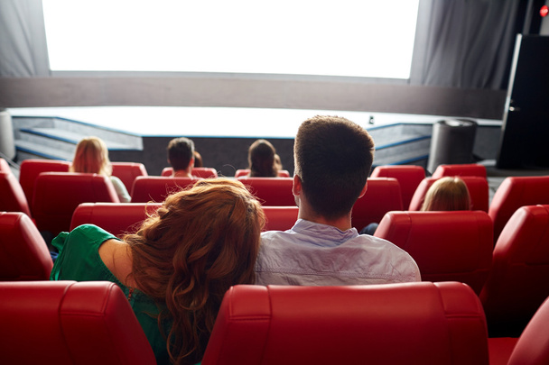 happy couple watching movie in theater or cinema - Фото, зображення