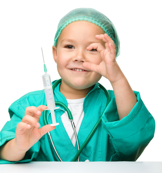 Little girl is playing doctor with syringe - Photo, Image