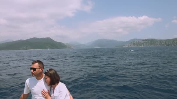 Couple in love on a yacht at sea. Boat traveling on the islands. Luxury holidays on the water. - Video, Çekim