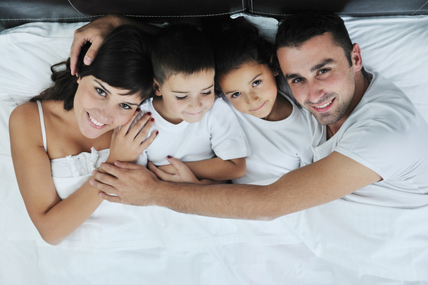 彼らの寝室で幸せな若い家族 - 写真・画像
