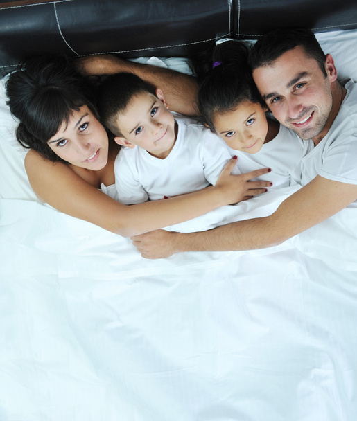 Happy young Family in their bedroom - Фото, изображение