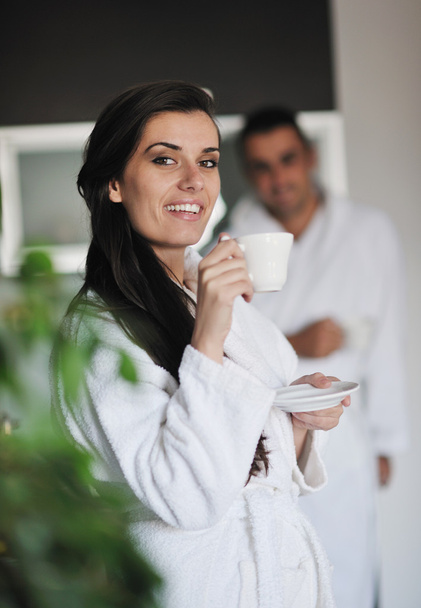 Young love couple taking fresh morning cup of coffee - Фото, зображення