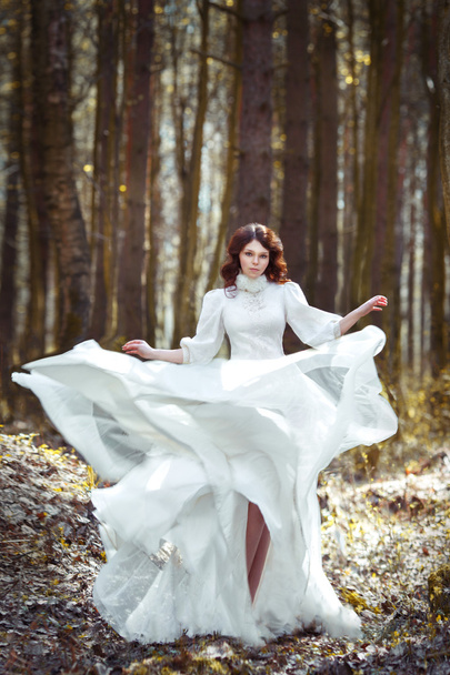 beautiful girl in a white dress with a skirt growing - Fotoğraf, Görsel