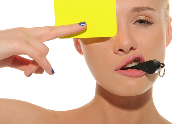 Beautiful woman with whistle and yellow card - Фото, изображение
