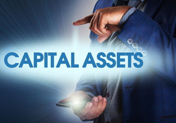 Businessman presses button capital assets on virtual screens. Bu - Photo, Image