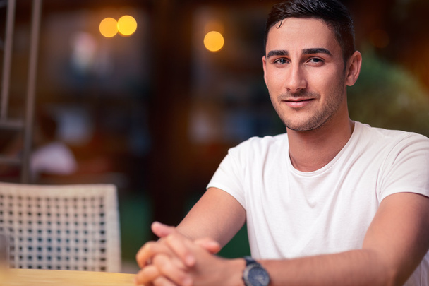 Young Man Sitting in a Restaurant - Foto, Imagen