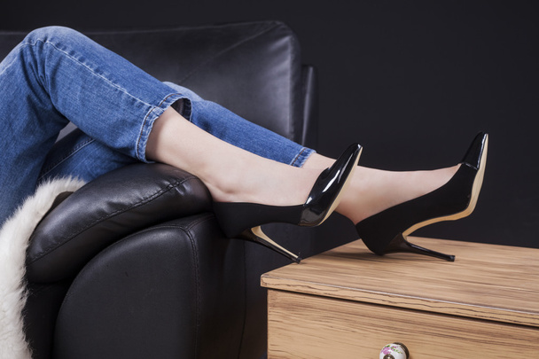 relaxed young woman with high heels - 写真・画像