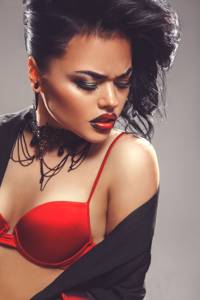 Sexy adult woman with closed eyes and make up in red bra - Fotó, kép