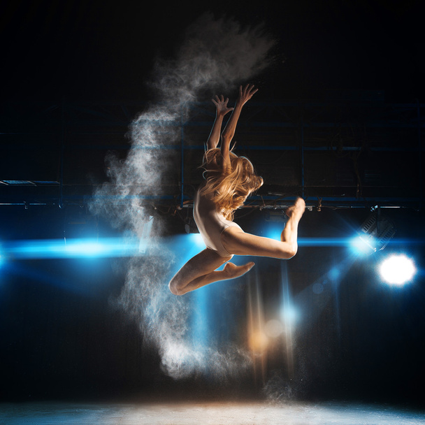 Blonde adult ballerina in jump on stage of theater - Valokuva, kuva