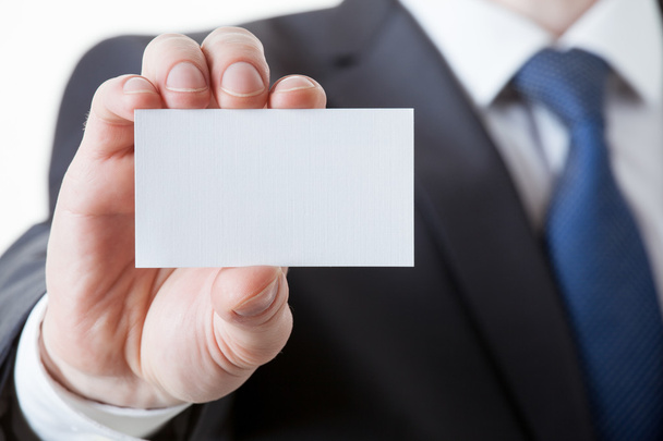 Unrecognizable businessman holding a visiting card - Foto, imagen