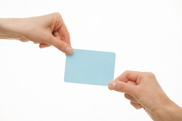 Kaksi kättä vetää eri suuntiin sininen paperi kortti
 - Valokuva, kuva