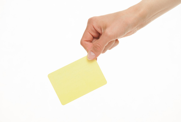 Female hand holding one yellow paper card - Photo, Image