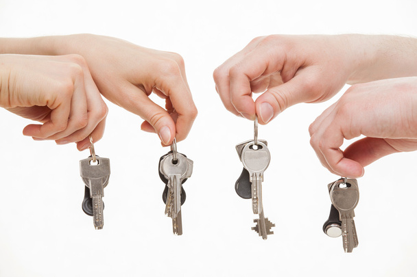 Four hands holding bunches of keys - Photo, image