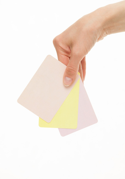 Female hand holding colorful paper cards - Fotoğraf, Görsel