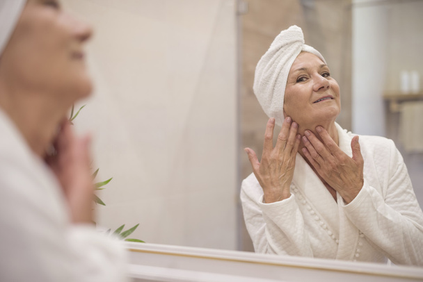 mature woman doing face massage - Photo, Image