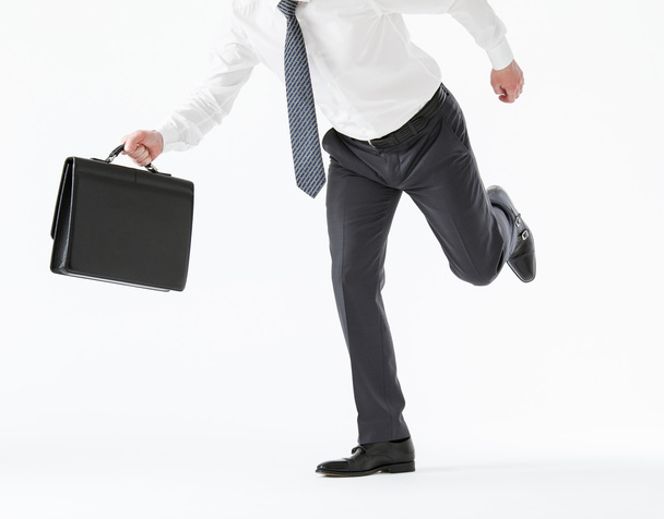 Businessman running with a briefcase - Foto, afbeelding