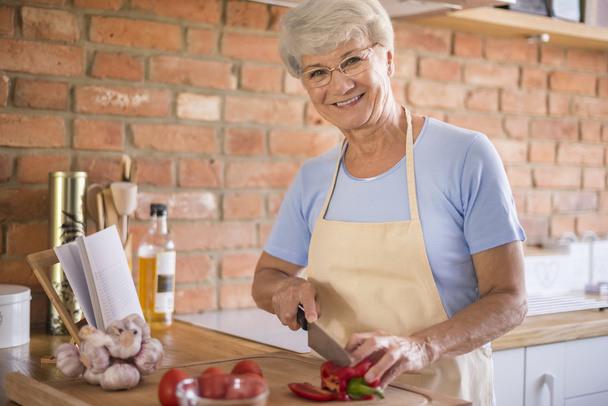 mature woman preparing tasty food - Φωτογραφία, εικόνα