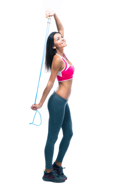 Smiling fitness woman holding skipping rope - Фото, зображення