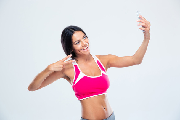 Happy fitness woman making selfie photo - Foto, imagen