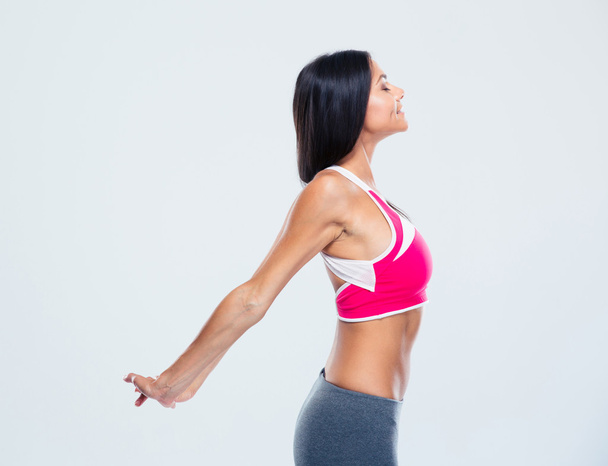 Happy fitness woman stretching hands - 写真・画像