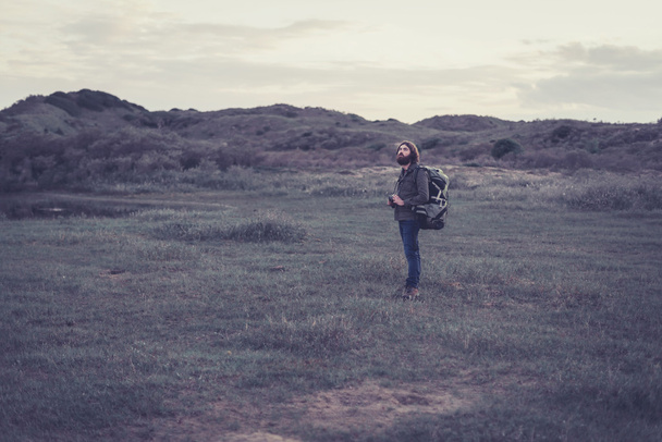Lonely backpacker in a remote wilderness - Fotoğraf, Görsel
