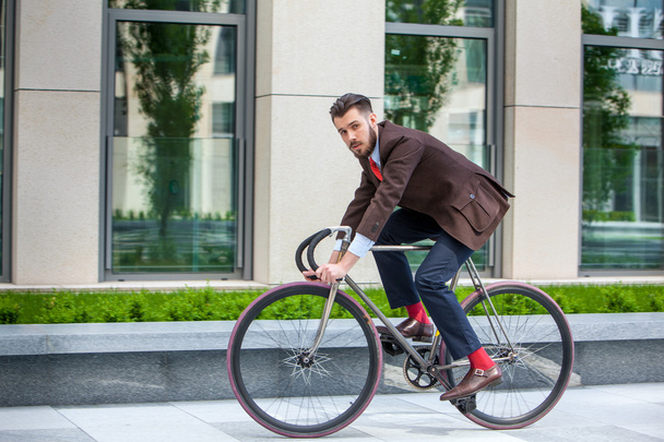 Handsome businessman and his bicycle - Zdjęcie, obraz