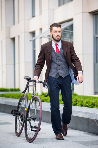 Handsome businessman and his bicycle - 写真・画像