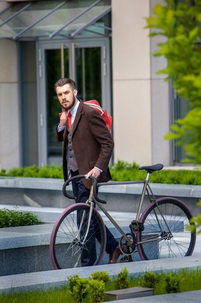 Handsome businessman and his bicycle - Фото, изображение