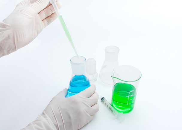 Colored solution in laboratory flasks - 写真・画像