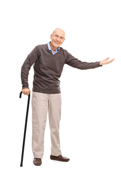 Senior with a cane gesturing with his hand  - Valokuva, kuva