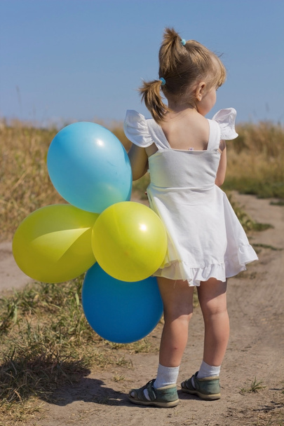 the girl in the field with balloons - Fotó, kép
