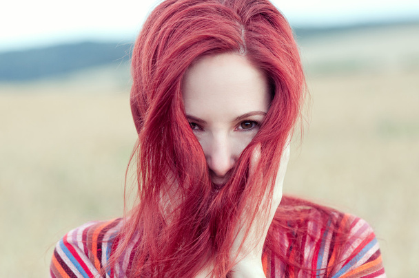 Outdoors portrait of beautiful woman with red hair - Photo, Image