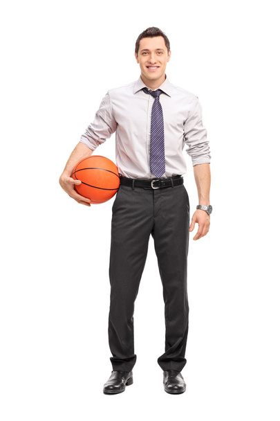Handsome businessman holding a basketball  - Zdjęcie, obraz