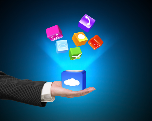 Hand showing cloud box illuminated app icons isolated on blue - Foto, afbeelding