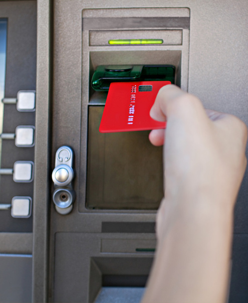 Woman using a cash point machine - Foto, afbeelding