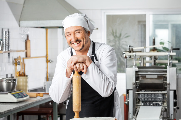 Cheerful Chef Leaning On Rolling Pin - Фото, зображення