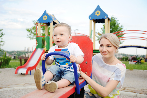 Mom and baby son play in the playground - Valokuva, kuva