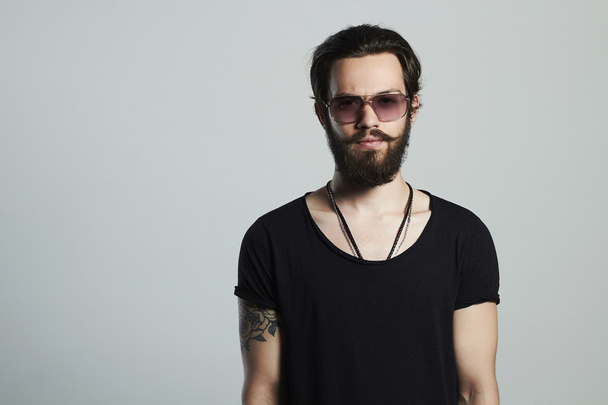 fashionable handsome man. Brutal bearded Sexy boy in trendy glasses - Photo, Image