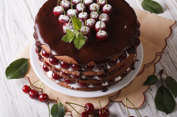Big cake with cherries and chocolate icing horizontal - 写真・画像