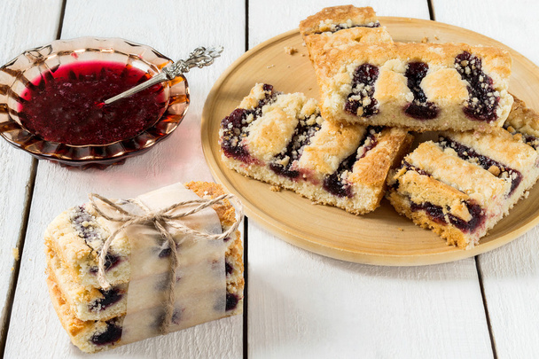 Cake with blueberry jam and jam in saucer  - Fotografie, Obrázek