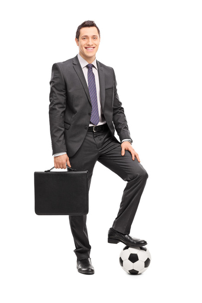 Businessman posing with a football  - Foto, immagini