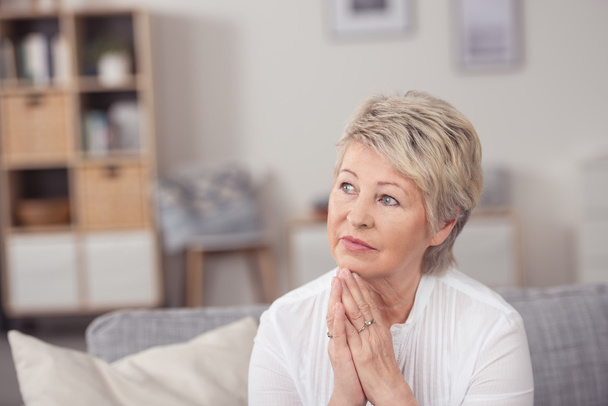 Thoughtful Middle Aged Woman Sits at Living Room - Foto, immagini