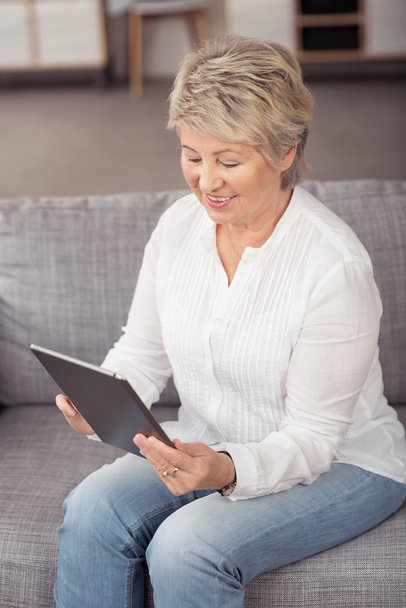 Happy Senior Woman Using Tablet at the Couch - Photo, Image