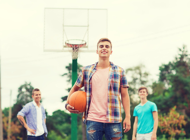 group of smiling teenagers playing basketball - Fotoğraf, Görsel
