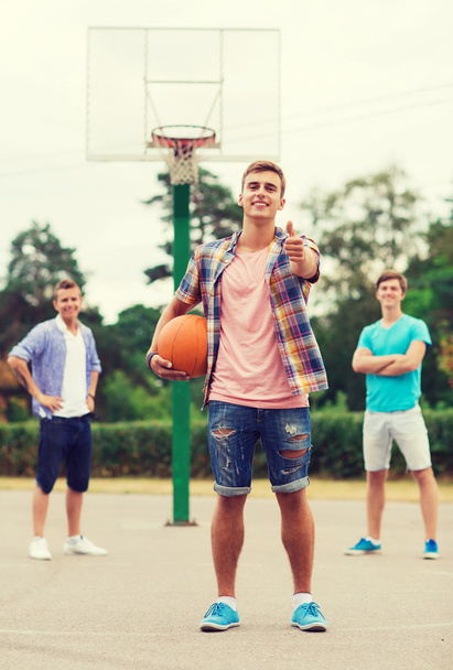 group of smiling teenagers playing basketball - Фото, изображение